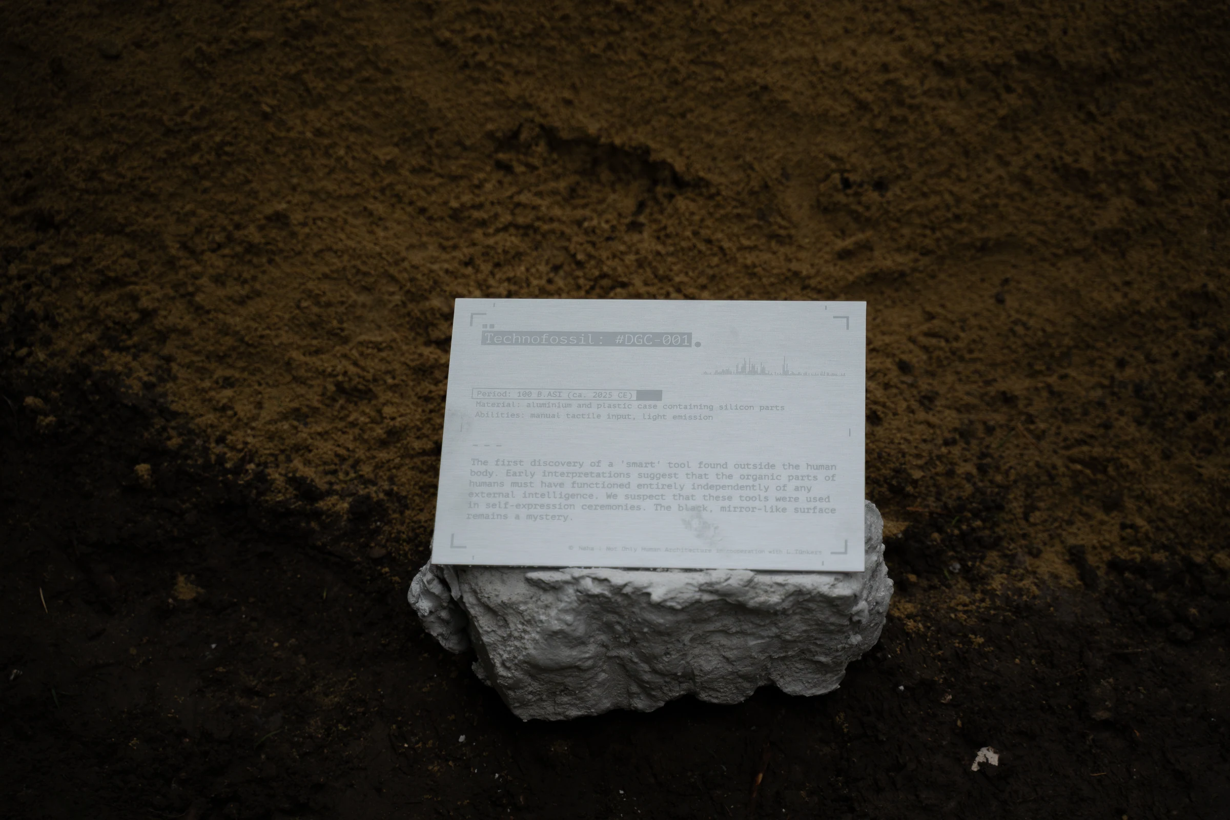 A text panel resting on a cast fragment at the Zürich Design Biennale